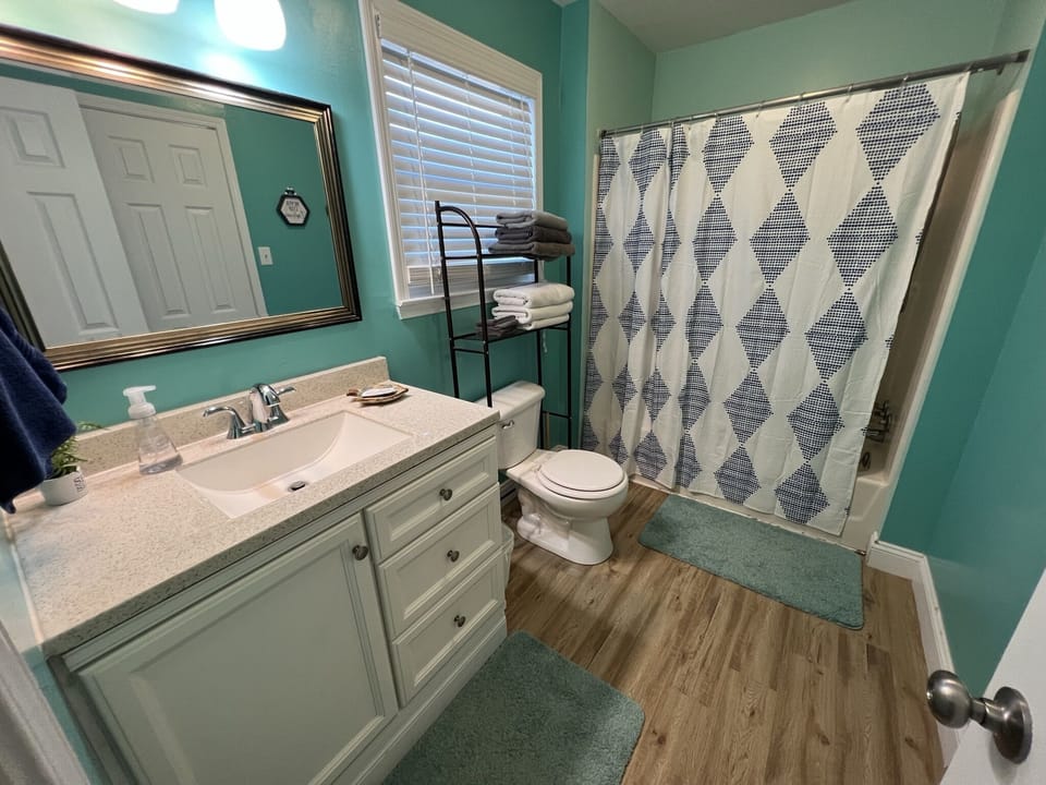 Refresh in the hall bathroom featuring a spacious vanity, plenty of storage, and a relaxing shower with fresh towels waiting for you.