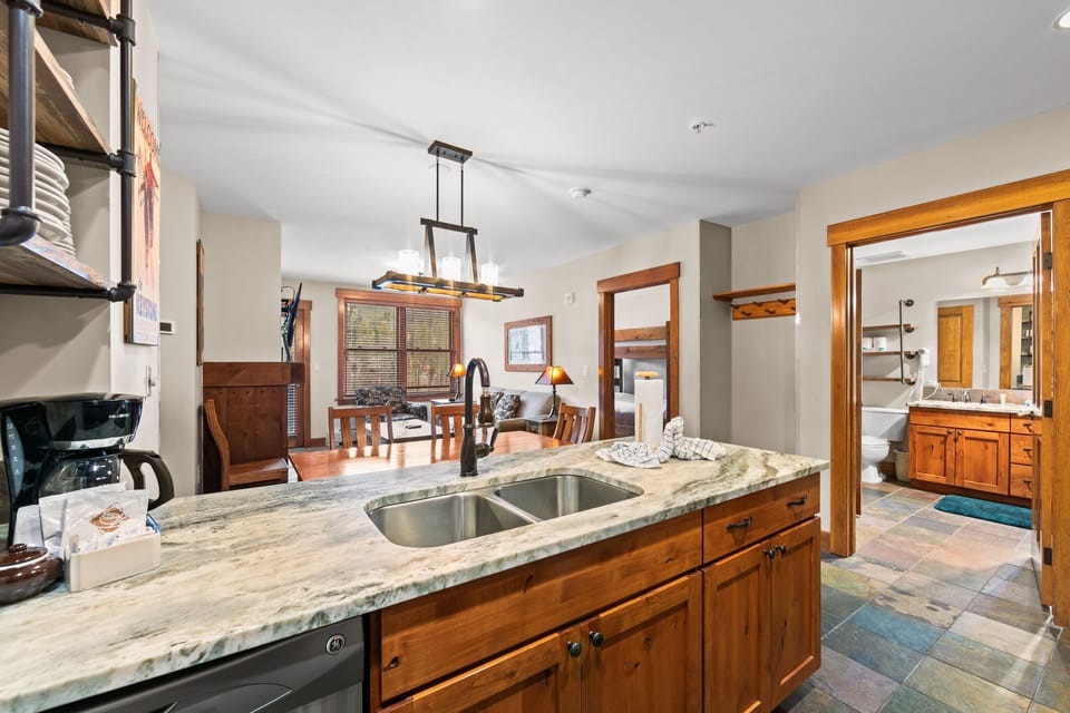 Your gourmet kitchen features granite counters and warm wood cabinetry, flowing seamlessly into the dining area for memorable meals together.