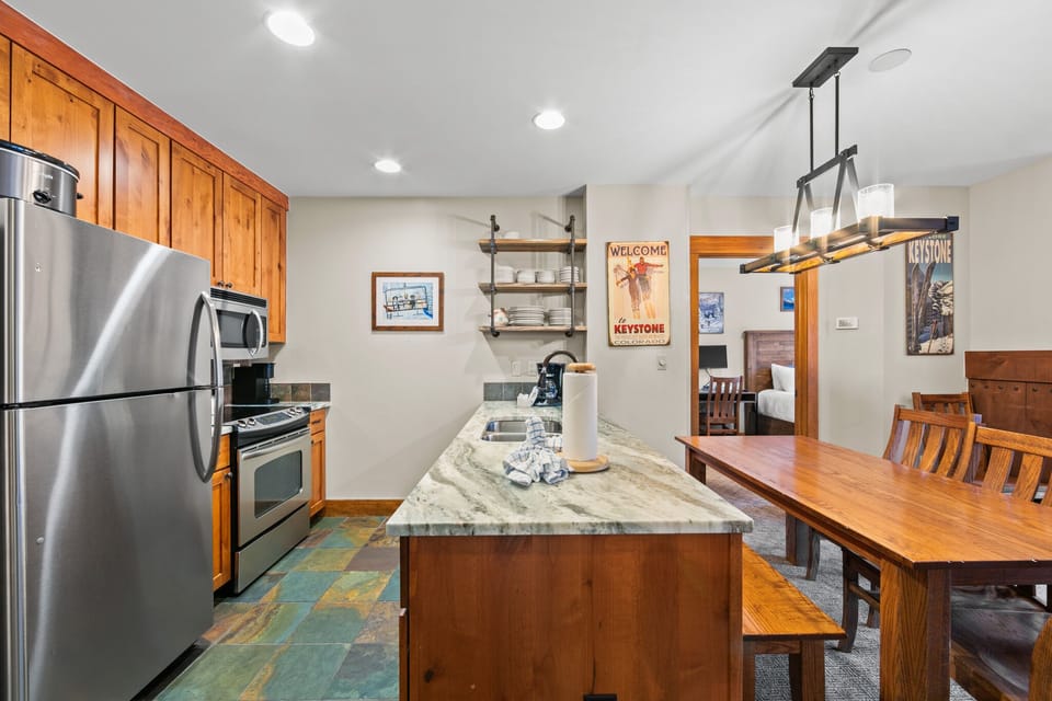 Your spacious kitchen features granite counters, stainless appliances, and a cozy dining area perfect for family meals.
