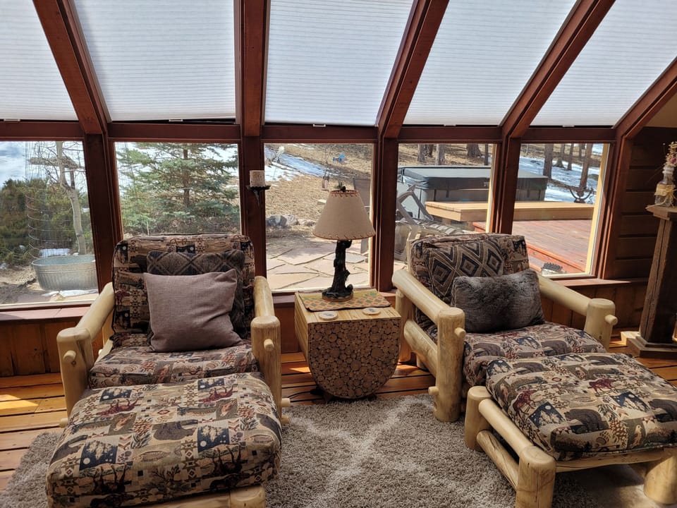 Sun room with new sun blocking blinds, leads out to hot tub and grill