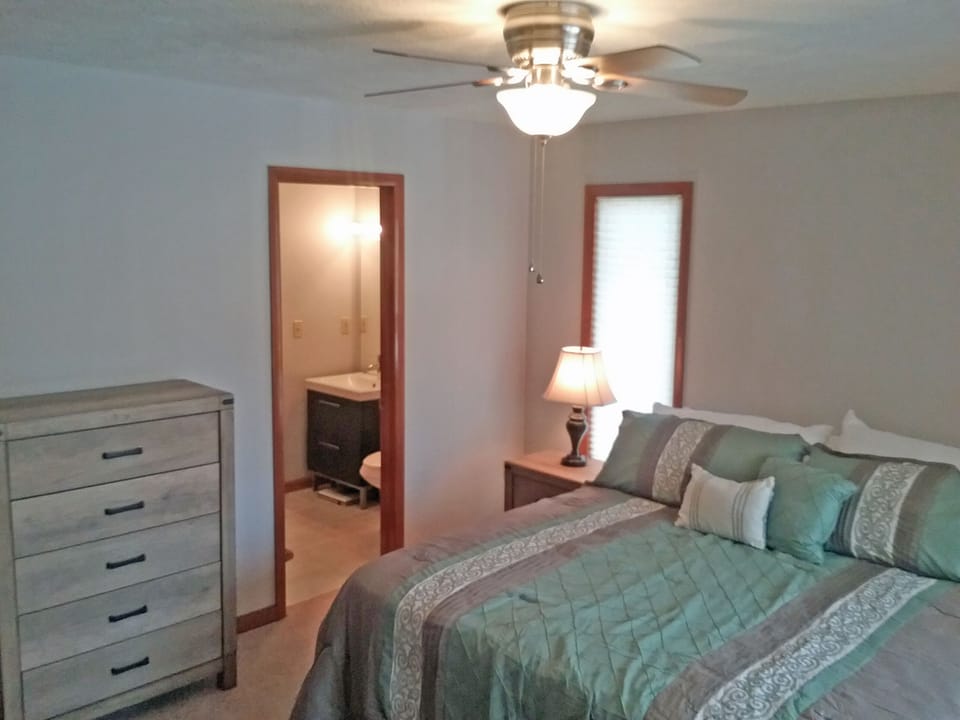 master bedroom includes a single roll away bed stored in closet for an 8th guest