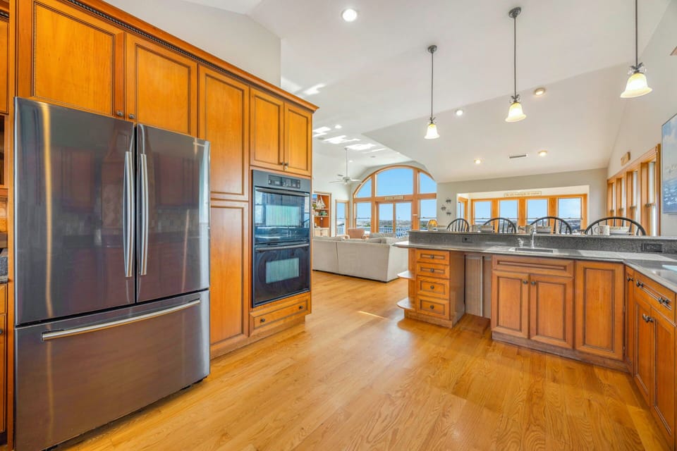 Your spacious gourmet kitchen features warm wood cabinetry, granite countertops, and stainless steel appliances, perfect for preparing memorable meals together.