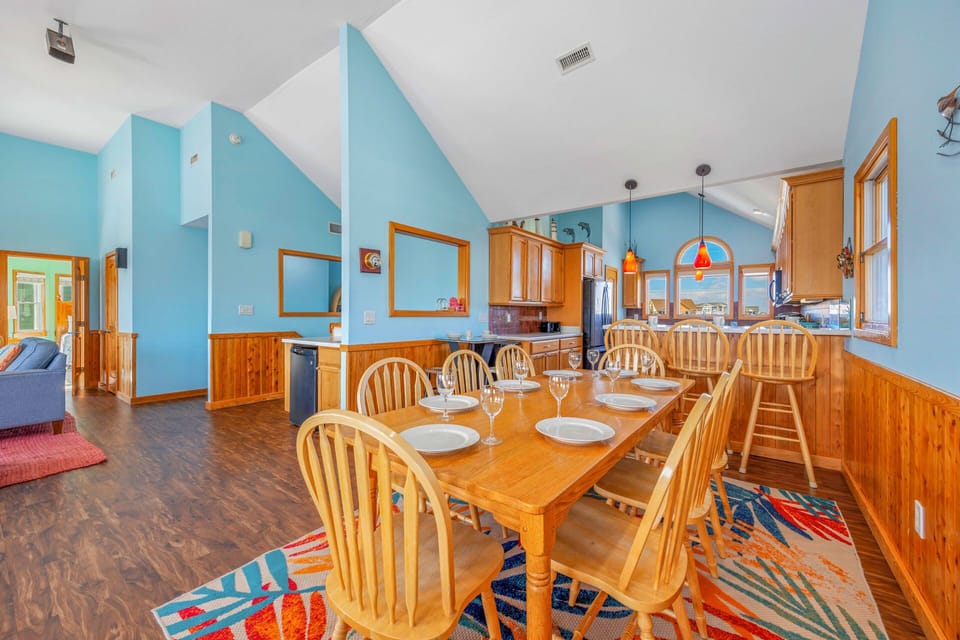 You'll love gathering around this spacious dining table with your group, sharing meals in the warm wood-accented kitchen.