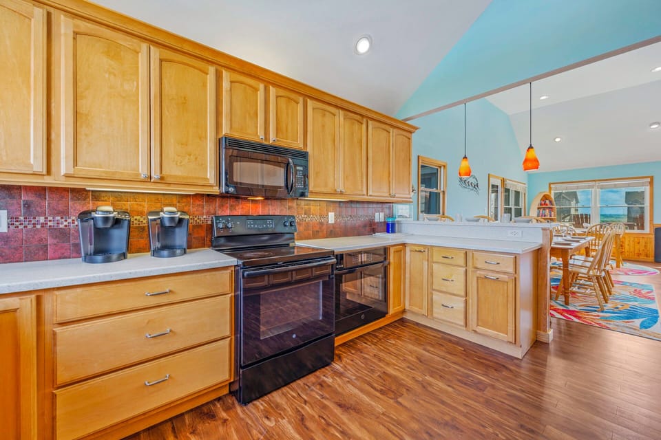 Your spacious kitchen features warm wood cabinets, granite counters, and modern appliances—perfect for preparing memorable meals together.