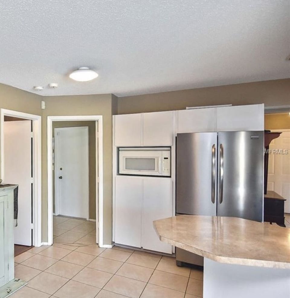 The second bedroom and utility room leading to garage entry are just steps away.