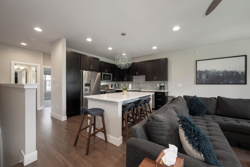 A gourmet kitchen with a slow-cooker, rice cooker, and plenty of pots and pans.