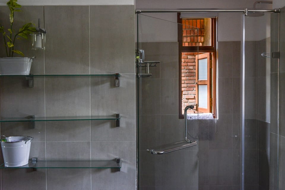 Shower, rainfall showerhead, slippers, towels