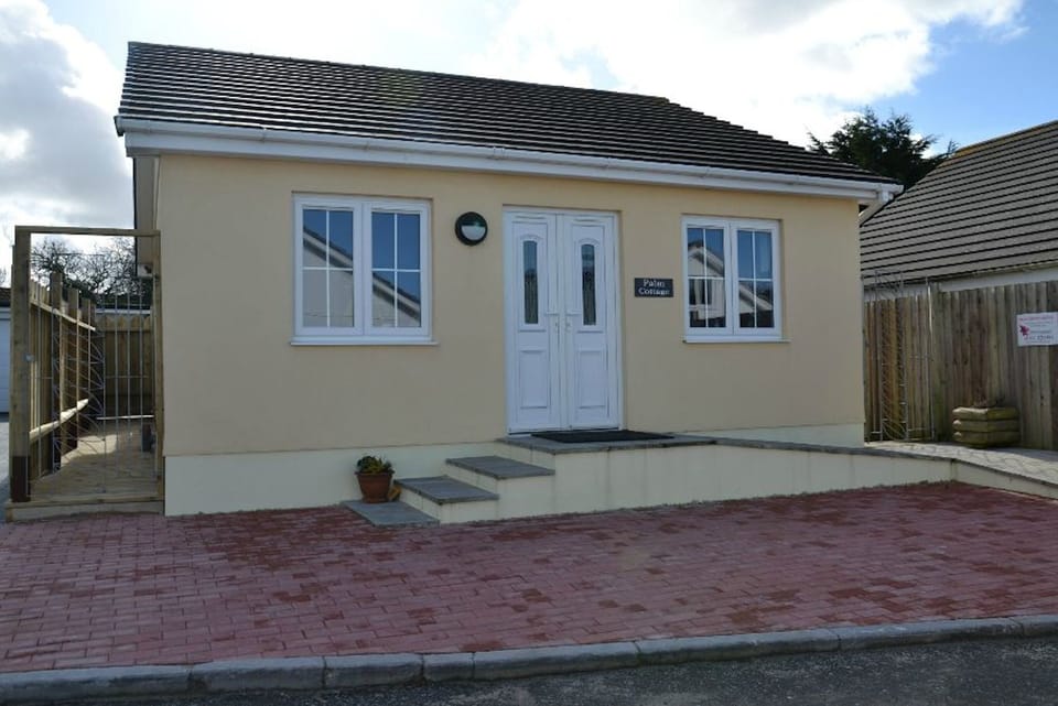 Front elevation with gates each side to enclose decking area 