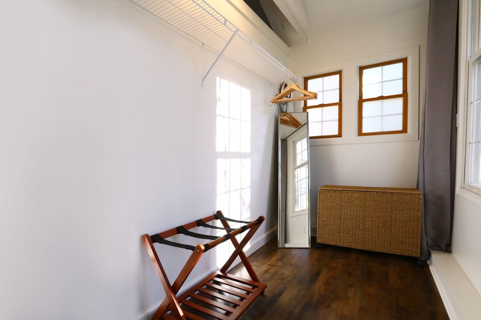 Large walk-in closet with full size floor mirror. 
