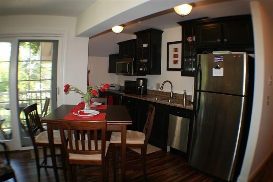 Our full kitchen with granite counters, stainless steel appliances & table for 6