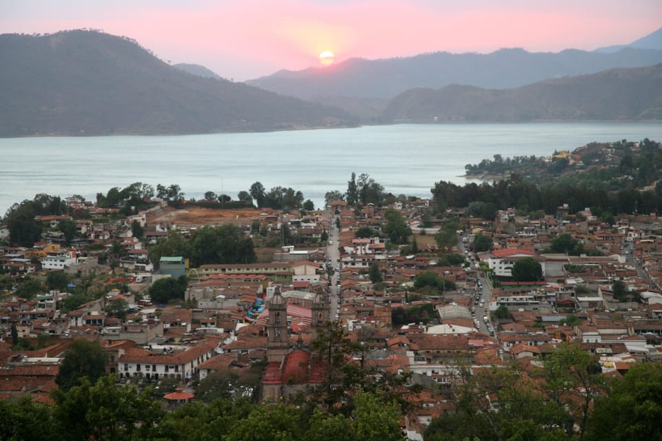 View of town with sunset directly across lake