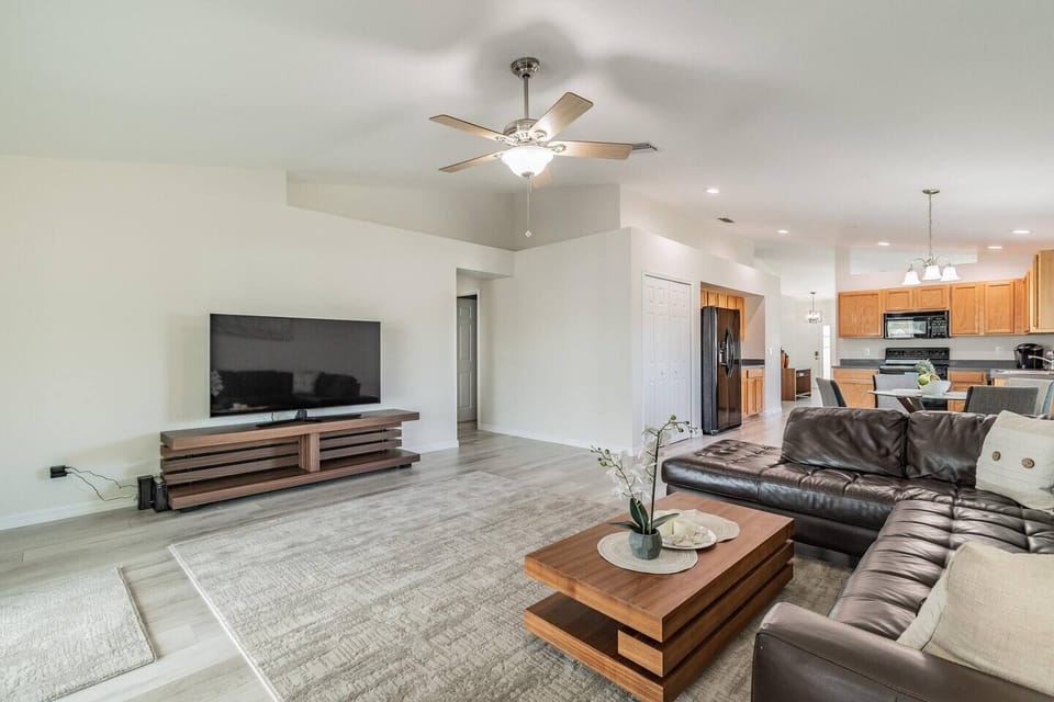 Open concept living room with 75 inch TV