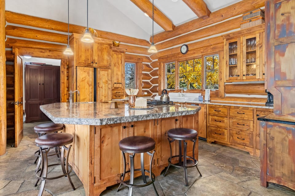 Spacious kitchen with granite island and rustic wood charm