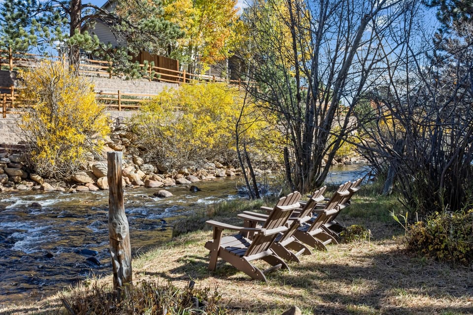 Peaceful riverside seating area surrounded by autumn colors