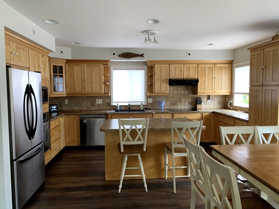 The “watch the cook “seats and dining room table for 8