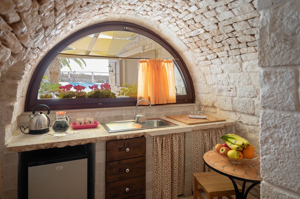 Junior Suite, Pool View (Trullo Verga) | Living area | 32-inch Smart TV with satellite channels