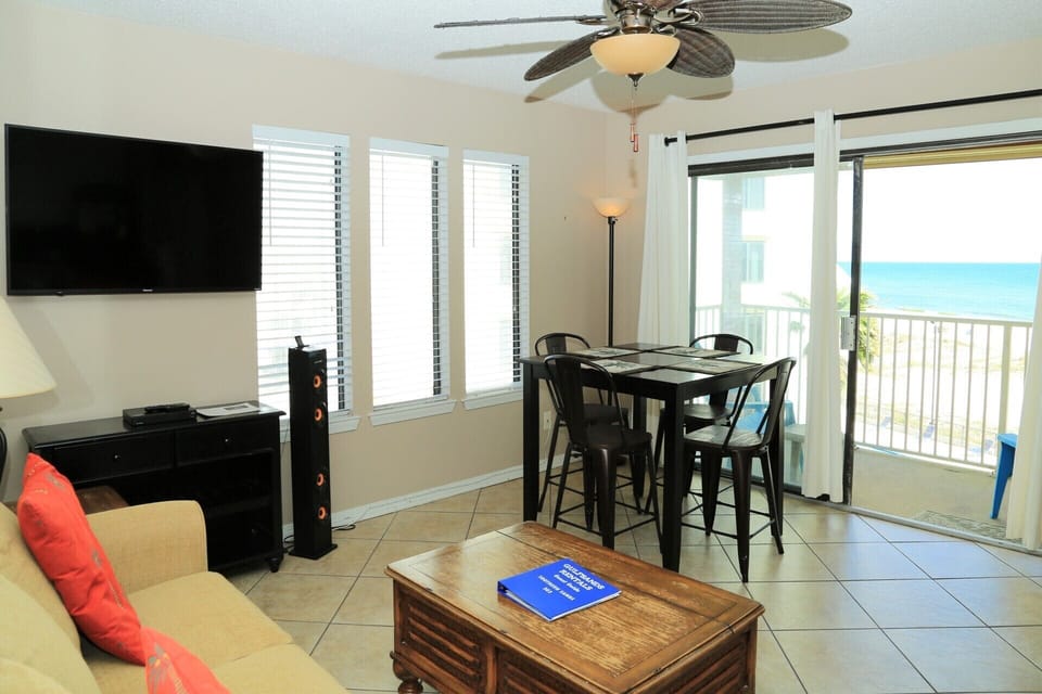 The sliding glass doors bring the outdoors in with sun-filled skies, pool & coastline views.