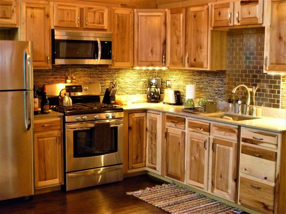 Full kitchen w/ stainless appliances, hickory cabinets & recycled quartz 