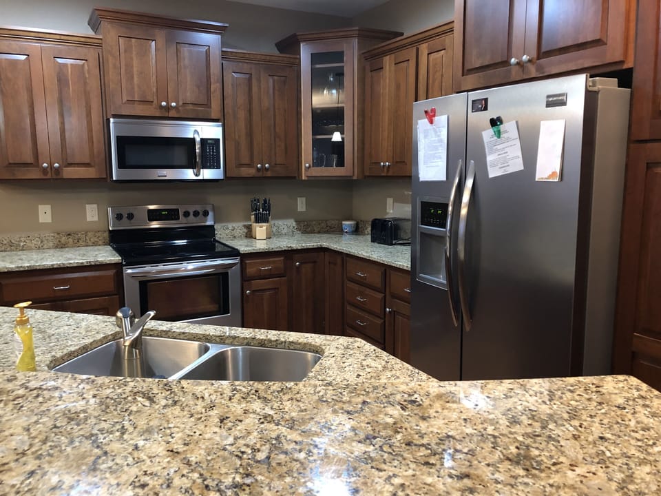 Fully stocked kitchen with paper towels, dish detergent and dishwasher packets 