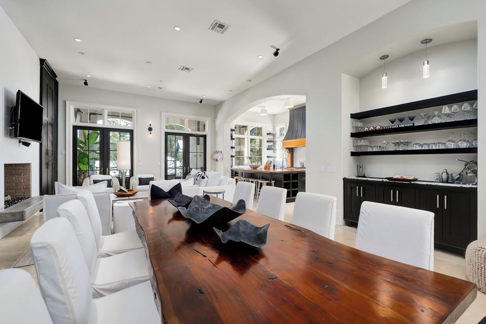 Open floor plan with chefs kiychen, dining for 10 and all crisp white living