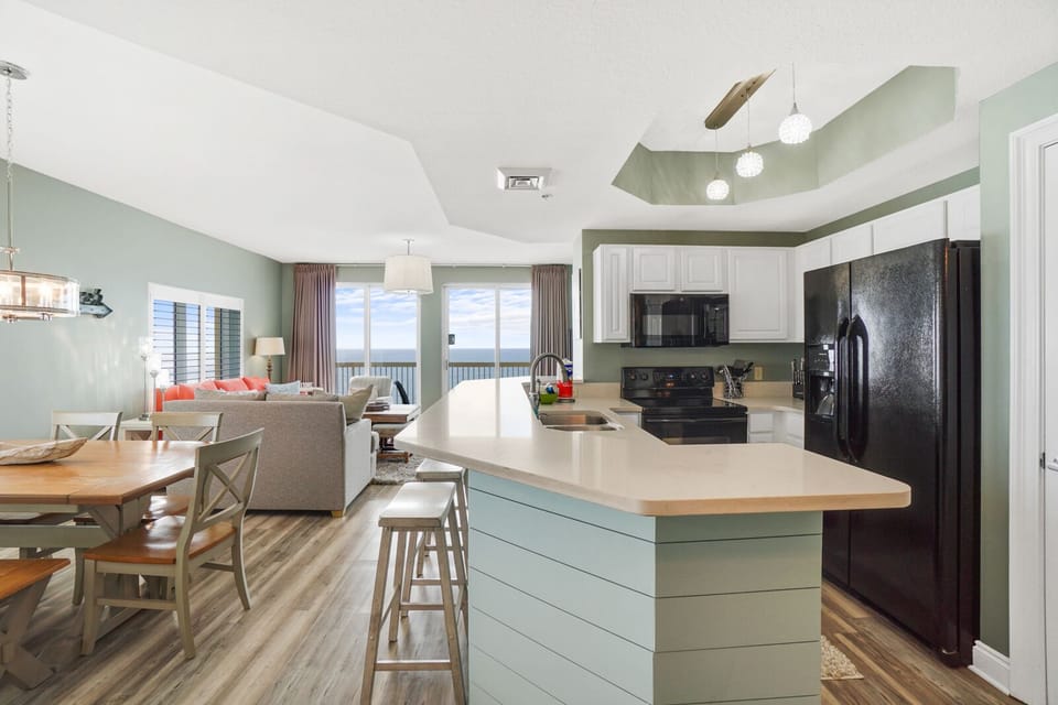 Your spacious open kitchen flows seamlessly into the living area, perfect for gathering and entertaining with modern appliances and coastal charm.