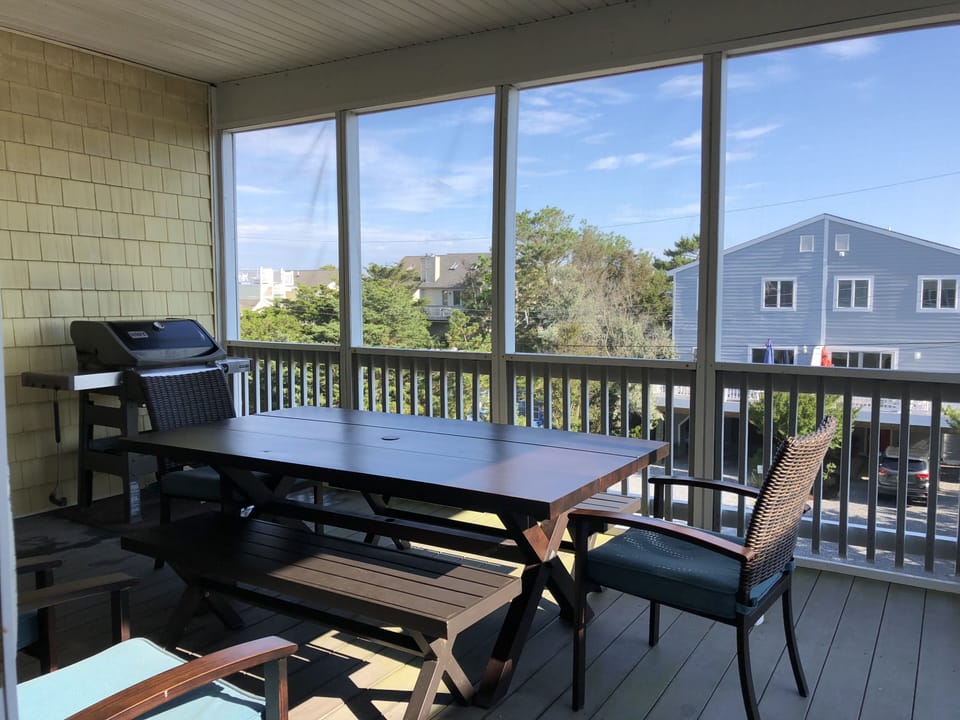 Main screened-in porch w/ grill and outdoor dining