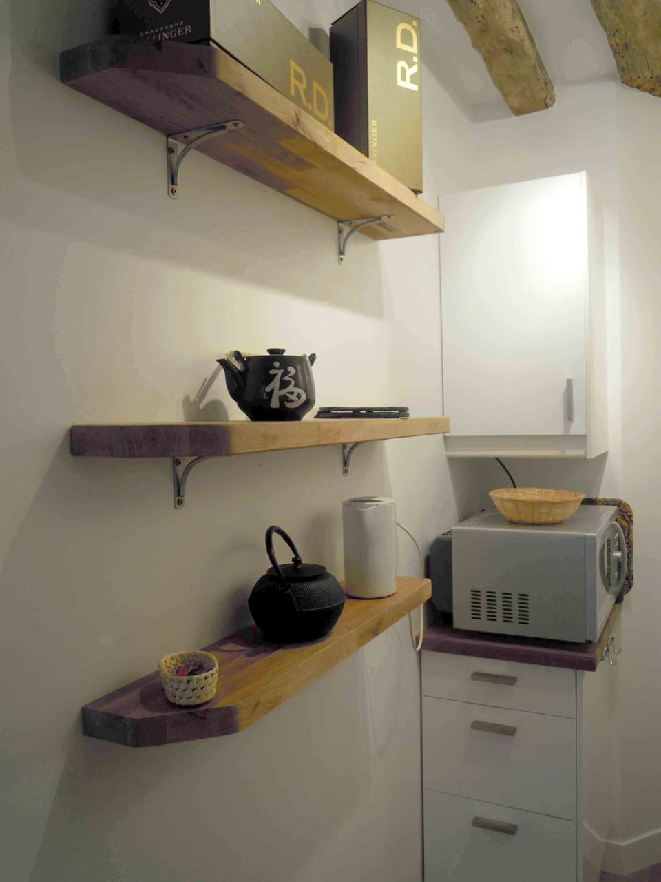 the kitchen, the owen combines microwave, the kettle and tea pot