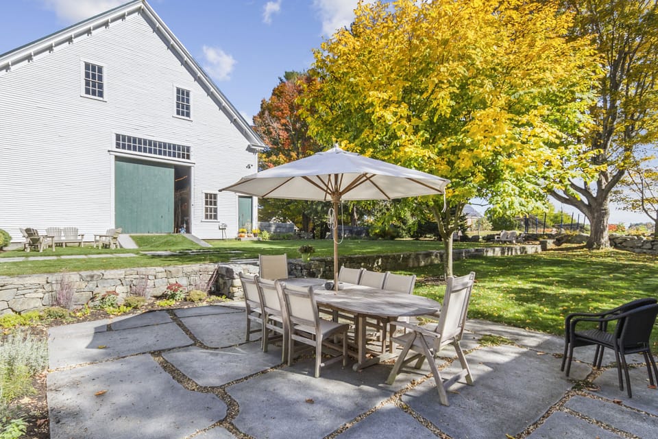 Terrace patio w space for games, and 5000 square-foot 1803 post and beam barn