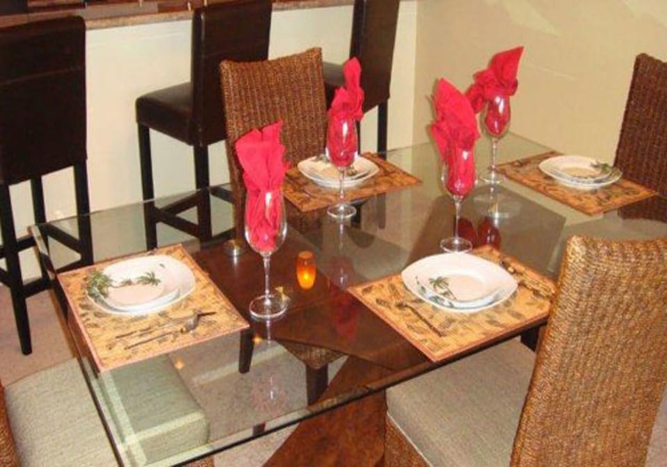 Comfy rattan backed, padded seating for four more at glass table.