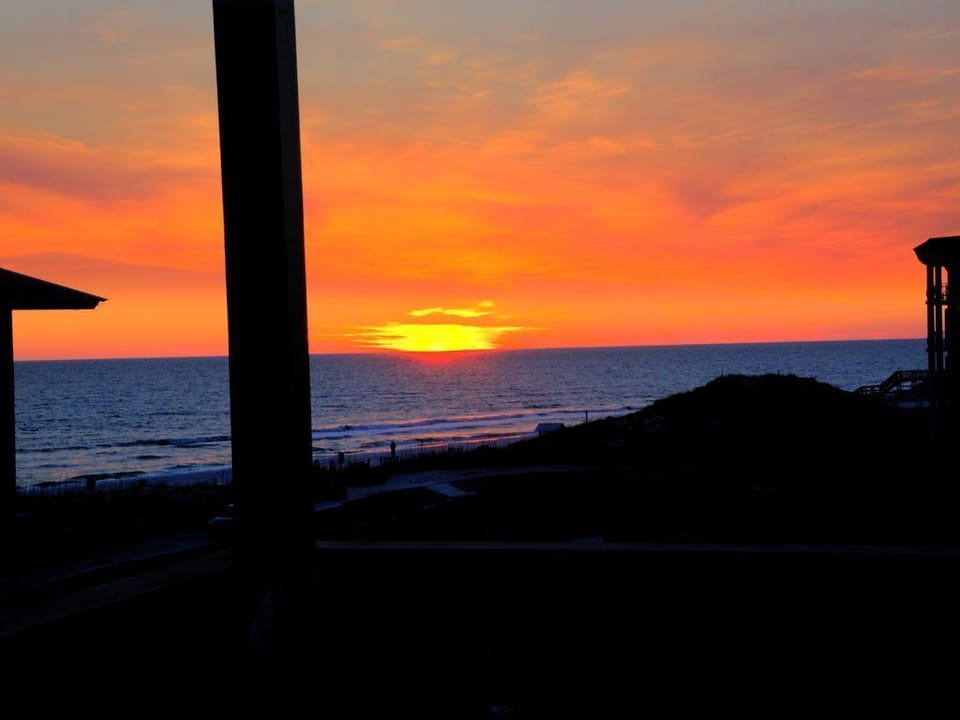 Sunset from upper deck. A twin size bed swing was recently added to relax and take in the gulf views from the top deck.