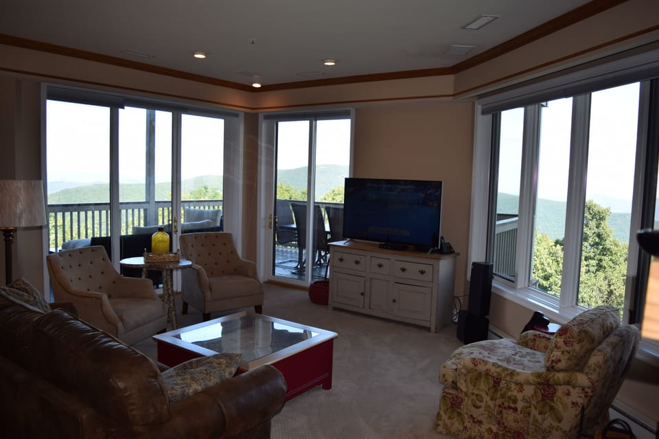 The living room has expansive views and a 55"  Ultra HiDef TV.
