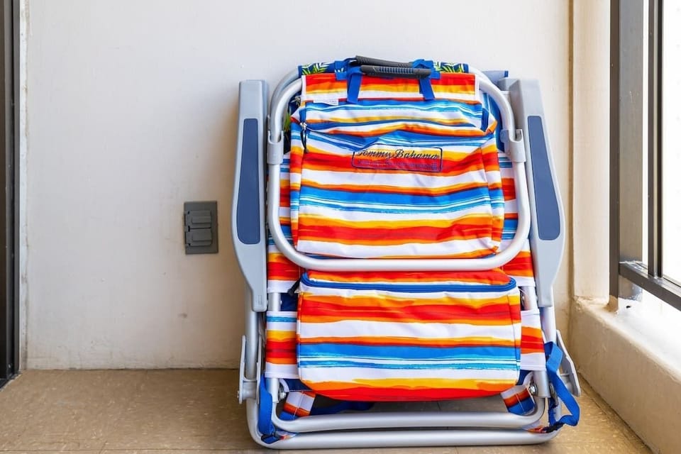 Two beach chairs and a beach umbrella are provided