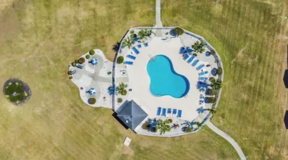 Aerial view of community pool and outdoor grilling area