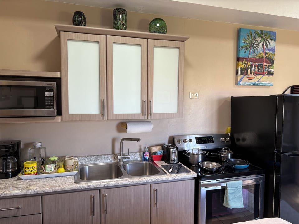 Full kitchen with pots pans and dishes to prepare meals in your suite.
