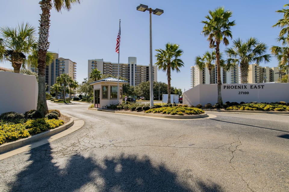 Complex Entry, Buildings, Palm Trees, Flag, Plants, Roads, Sky.