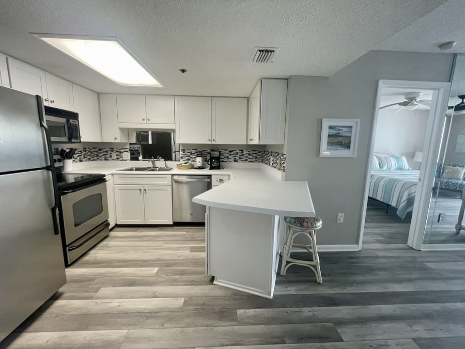 Kitchen, Hardwood, Ceiling Fan, Art, Stainless Appliances, Cabinets, Bed, Mirror