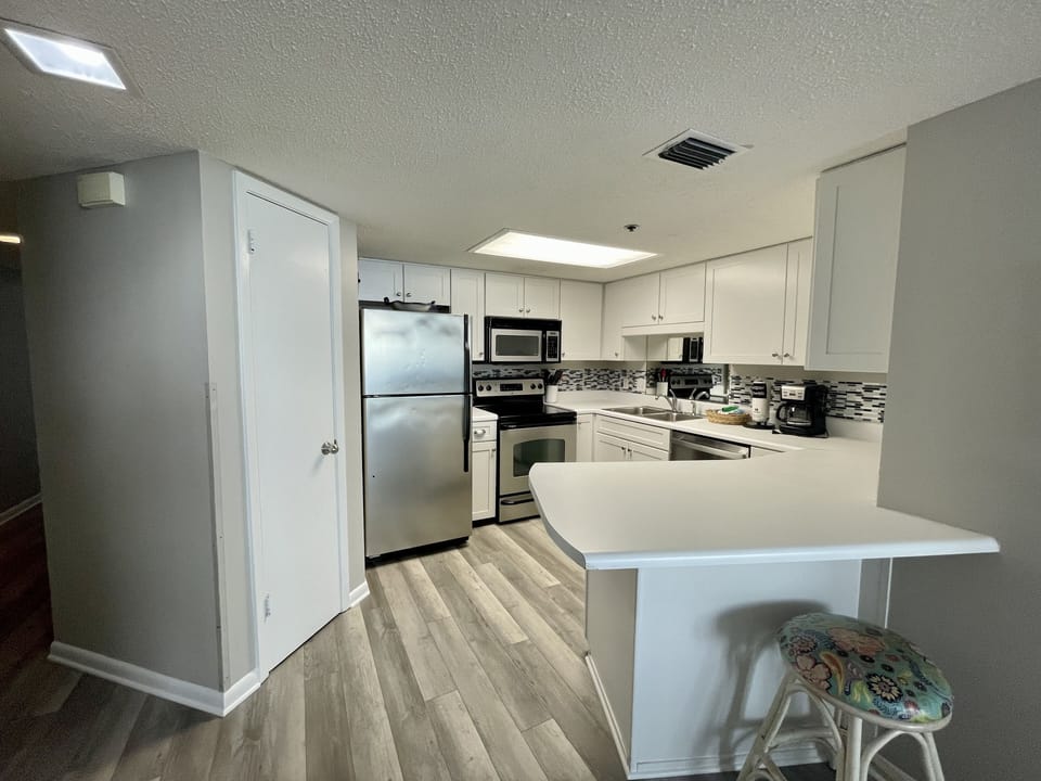 Kitchen, Hardwood Floor, Stainless Appliances, Cabinets, Tile Backsplash, Coffee
