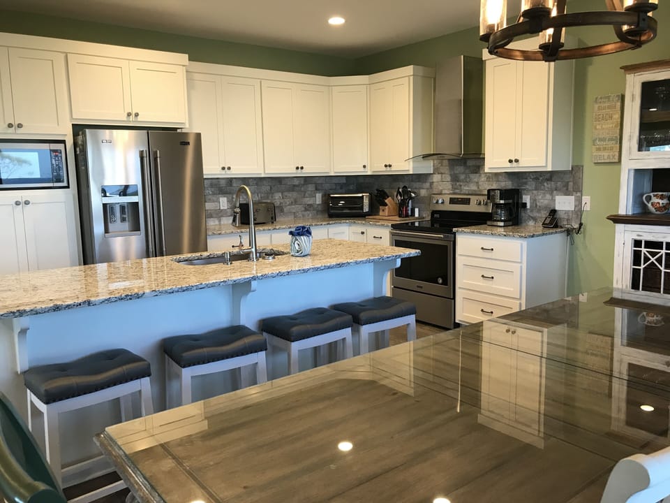 seating at the breakfast bar and dining room table