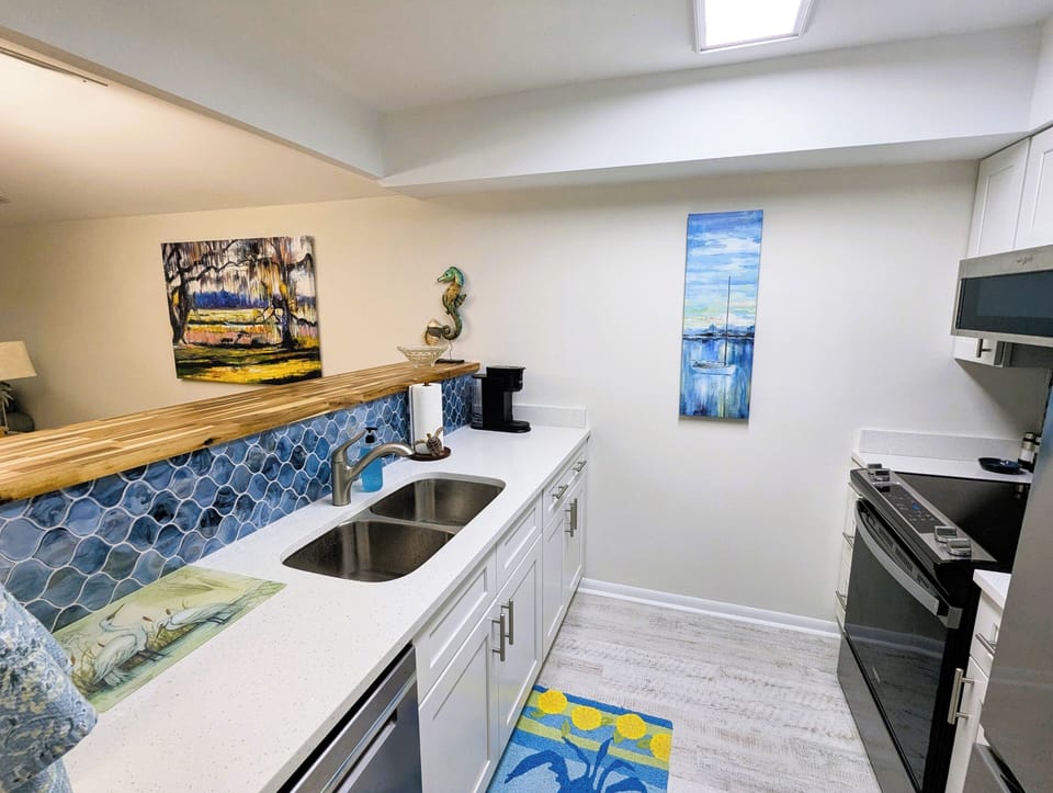 Kitchen with quartz countertops and designer tile