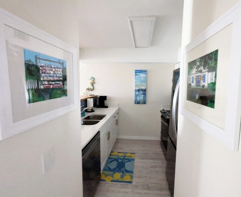 View of kitchen from hallway with natural light