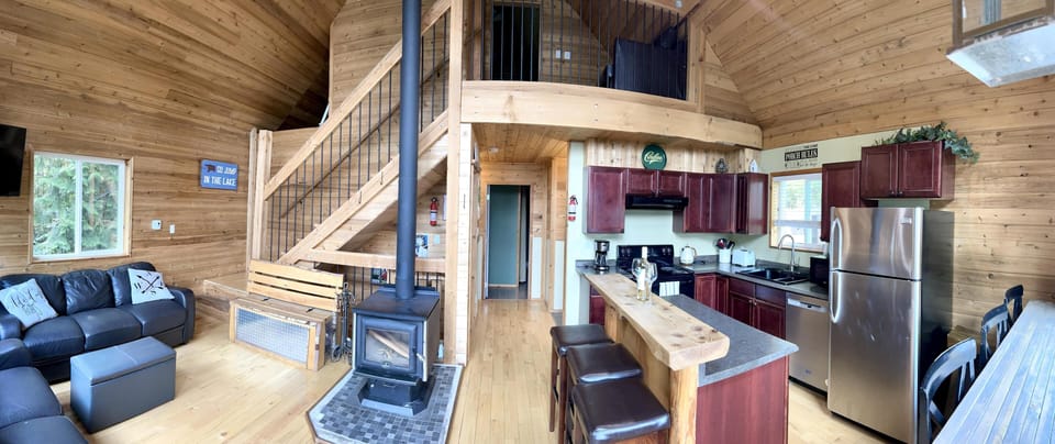 Spacious open-concept living and kitchen with cozy wood stove