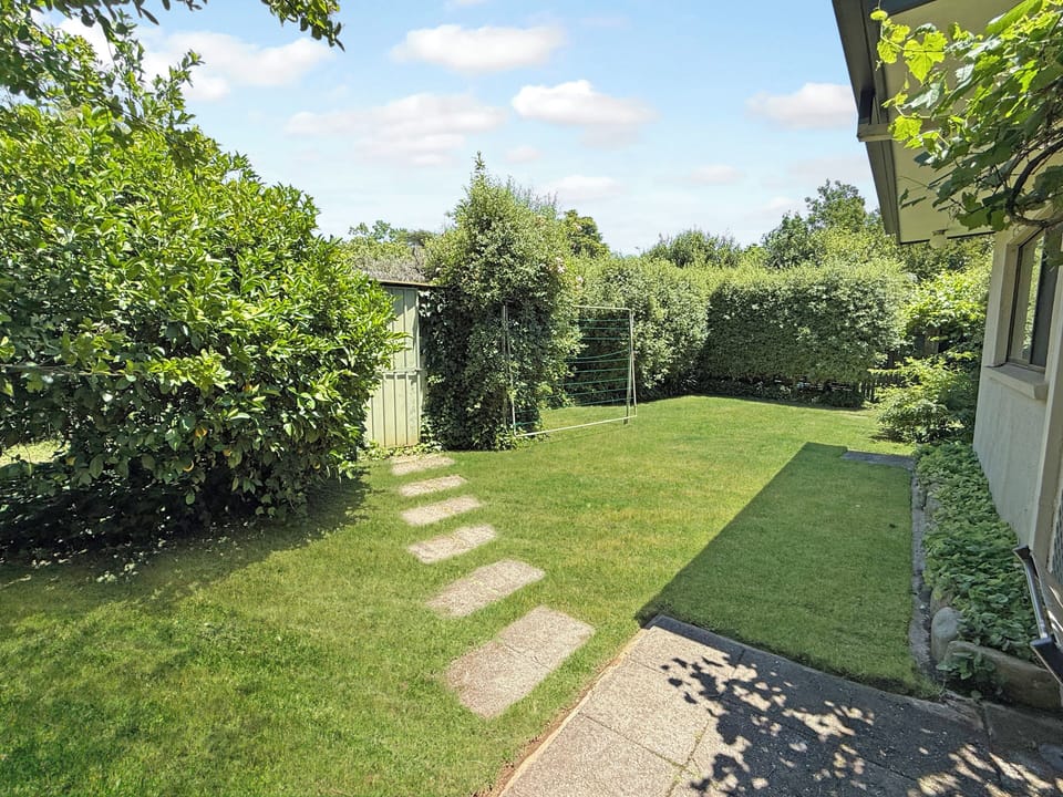 Fenced large garden.  Big enough to throw a ball.  Bike shed with power points