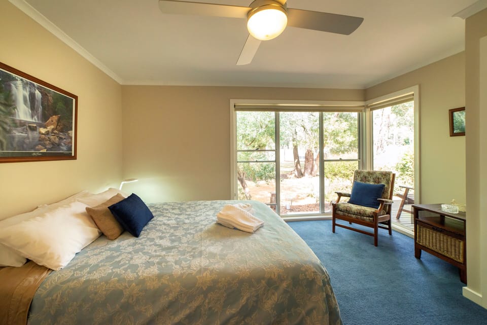 Cozy elegance: Main bedroom, queen bed, refreshing ceiling fan. Your perfect sanctuary. 