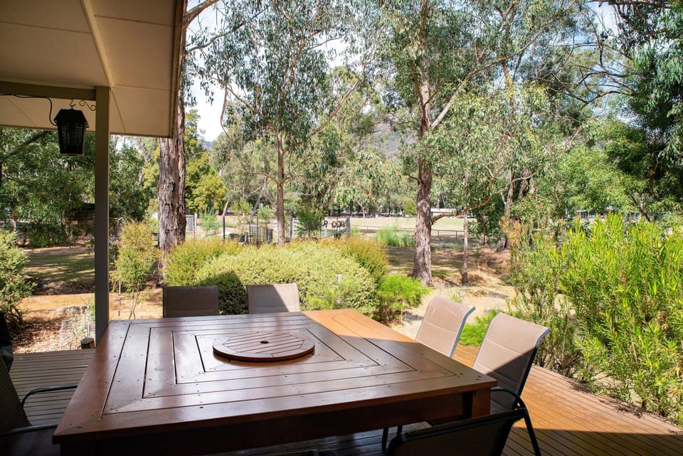 Savor open-air dining on a spacious deck with a massive table.