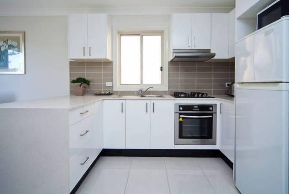 Modern fully equipped kitchen with quality appliances