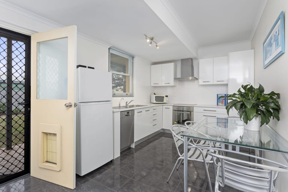 Full size kitchen with dishwasher, crockery, cutlery, pots and pans