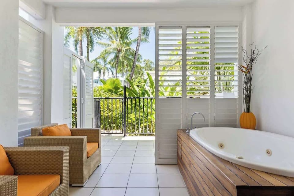 Unwind in the ensuite's jetted spa bath while gazing at the refreshing outdoor views, creating a serene oasis for relaxation.


