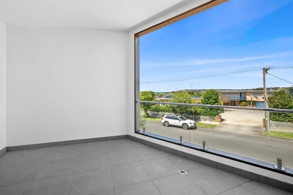 Sheltered west-facing balcony, which has since been furnished with an outdoor dining setting