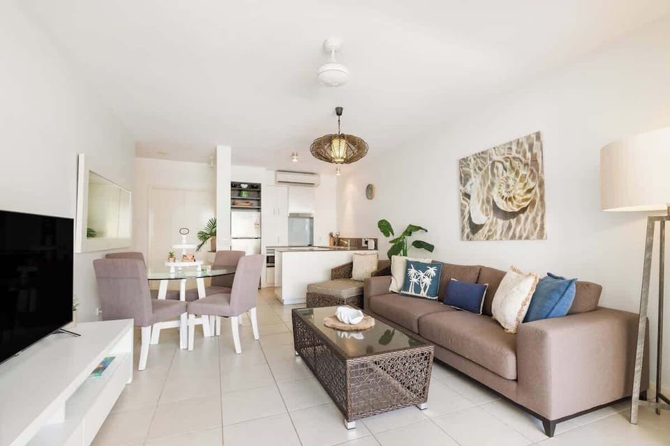 Unwind in the earth-tone living area, offering a touch of ocean feels for a tranquil escape.