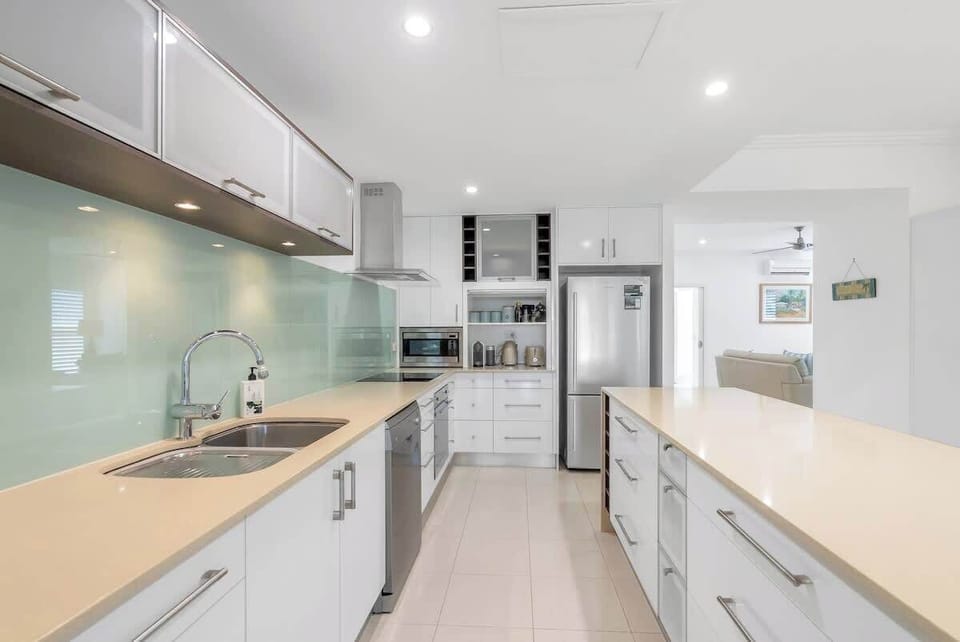 Cook up a feast in the fully equipped kitchen, featuring modern appliances, sleek cabinetry, and plenty of bench space.